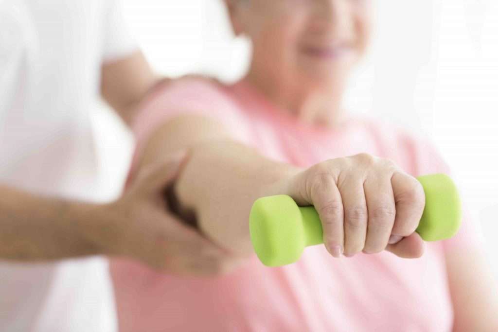 Geriatrics: Physical rehabilitation for older patients whilst the patient is holding minor dumb-bell